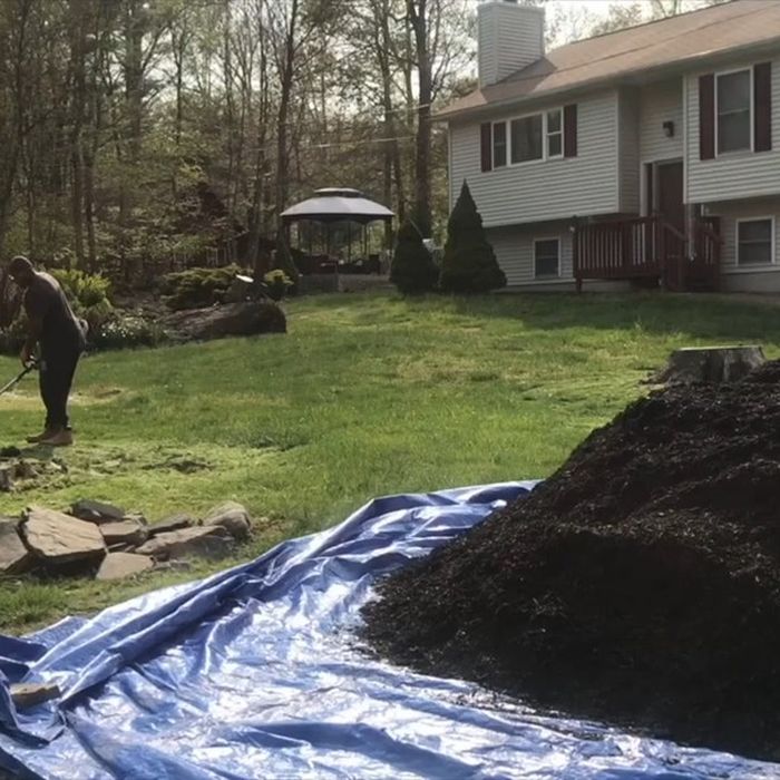 Fresh mulch delivered on a tarp before bed installation