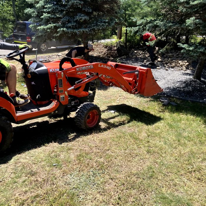 Compact loader moving soil for a hardscaping job