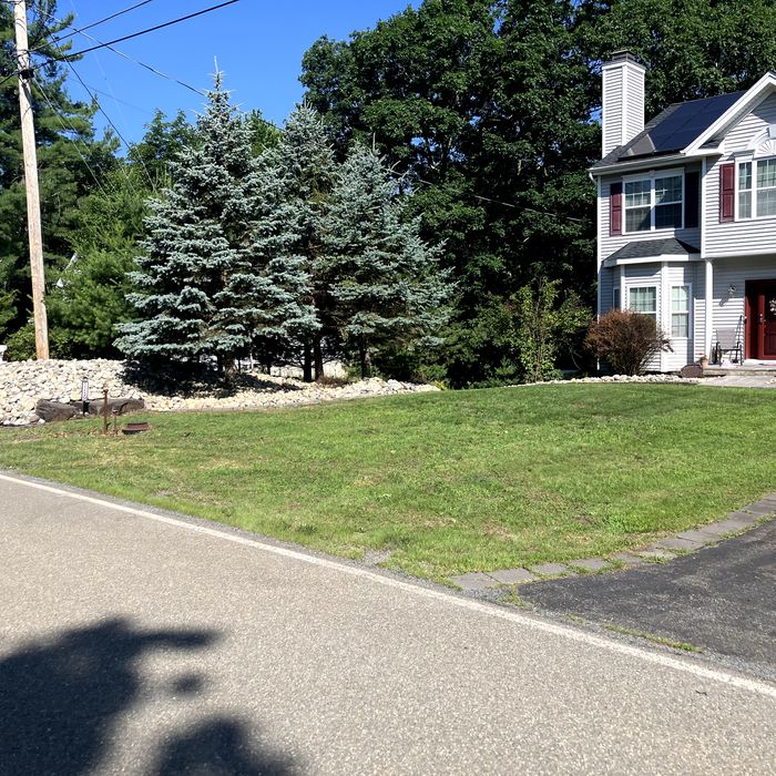Stone bed and clean driveway edge after a cleanup